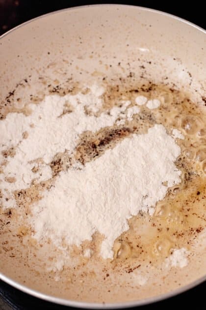 Sprinkle flour into skillet.