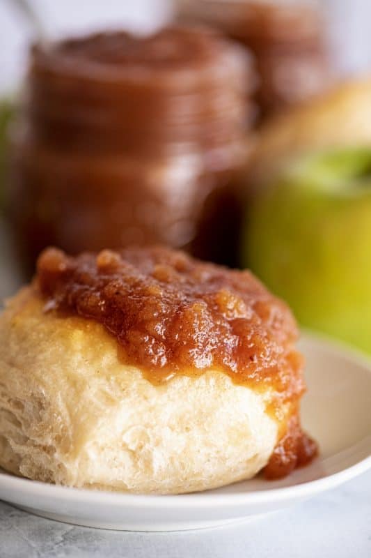 Close-up of crockpot apple butter on a spoon roll.