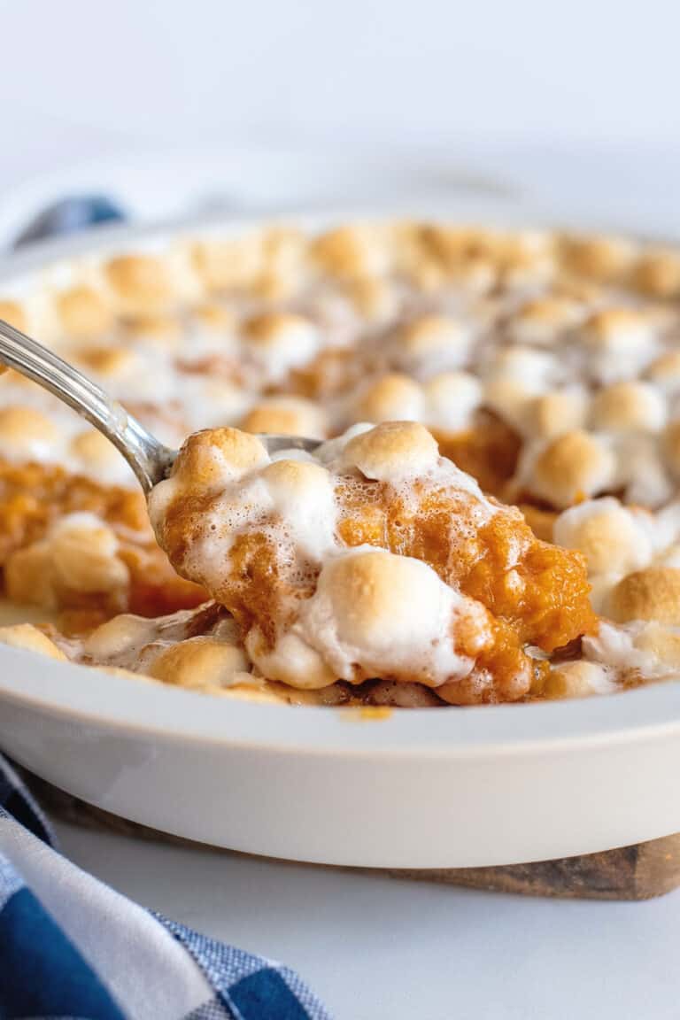 Spoonful of sweet potato casserole with marshmallows.