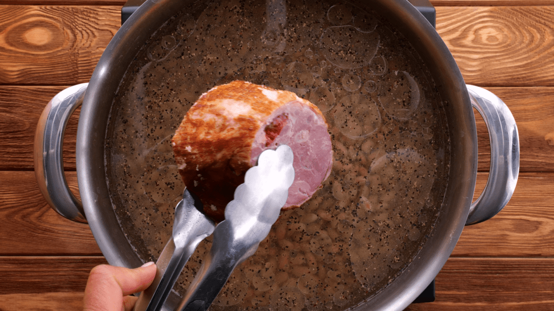 Add ham hock to pot with dried beans.