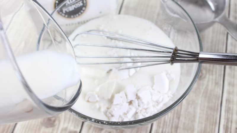 In separate bowl, mix together the flour and remaining milk.