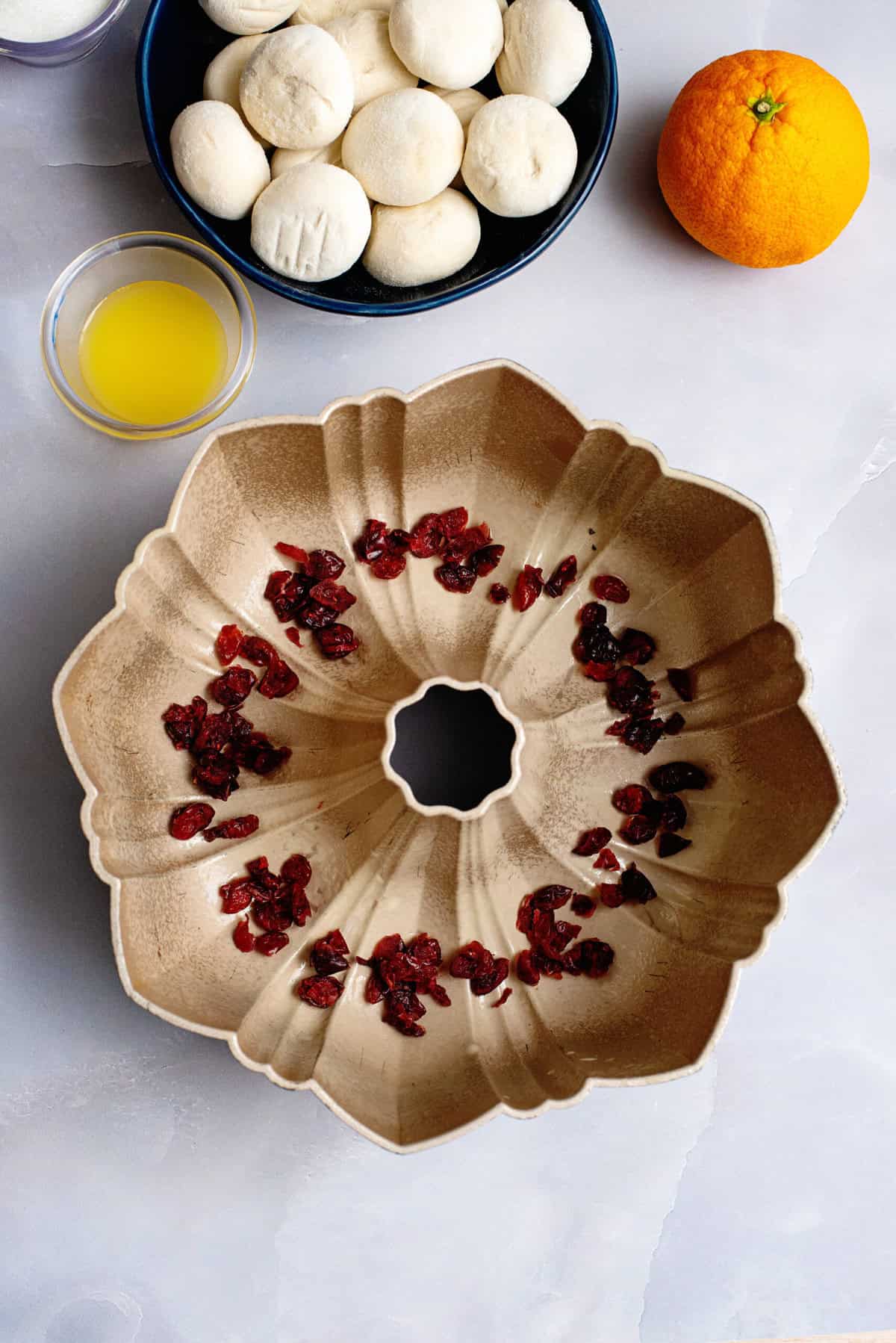 sprinkle dried cranberries on the bottom of the bundt pan