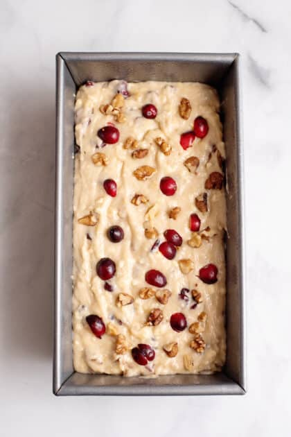Pour banana bread batter into prepared loaf pans.