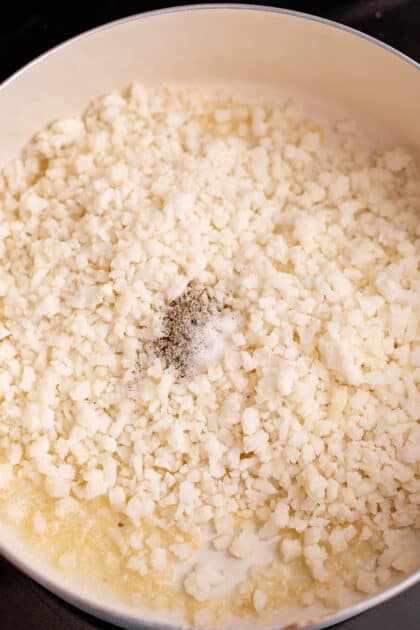 Add cauliflower to skillet with salt and pepper.
