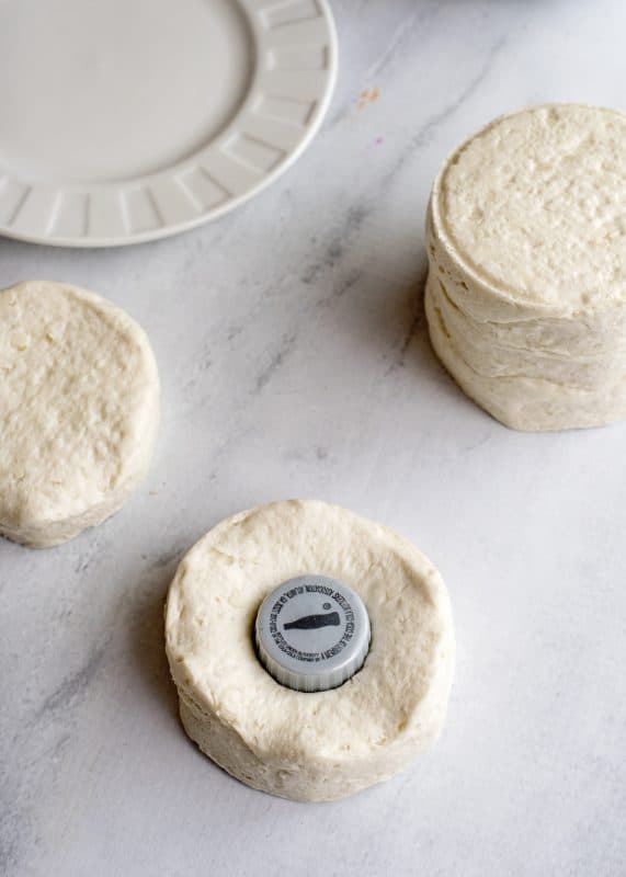 Use bottle cap to cut hole in doughnut.