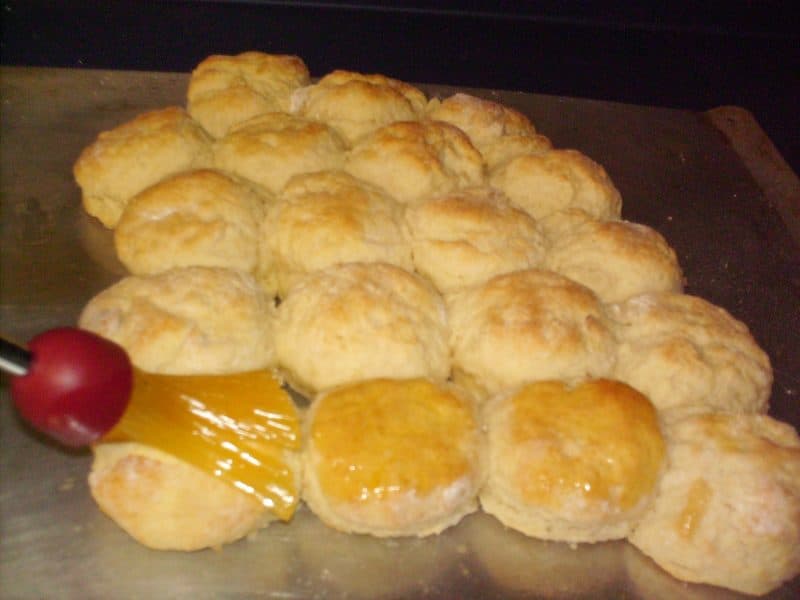 Brush melted butter on buttermilk biscuits