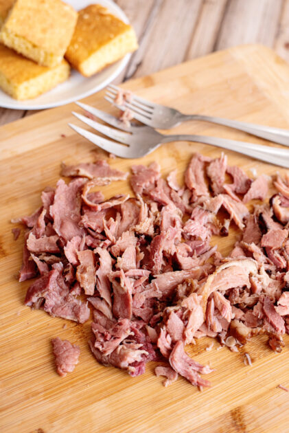 Remove ham, shred it, and add it back to the pot.