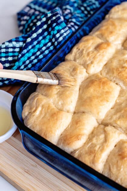 Brush yeast rolls with butter once baked.