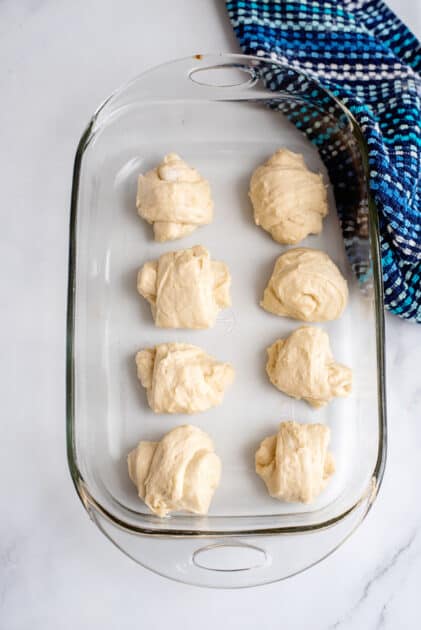 Place yeast rolls in a baking dish.