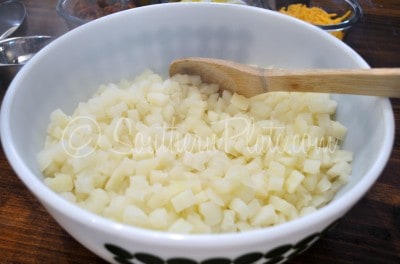 Place cooked potatoes in a large bowl.
