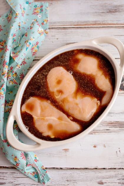 Marinated chicken breasts in baking dish.