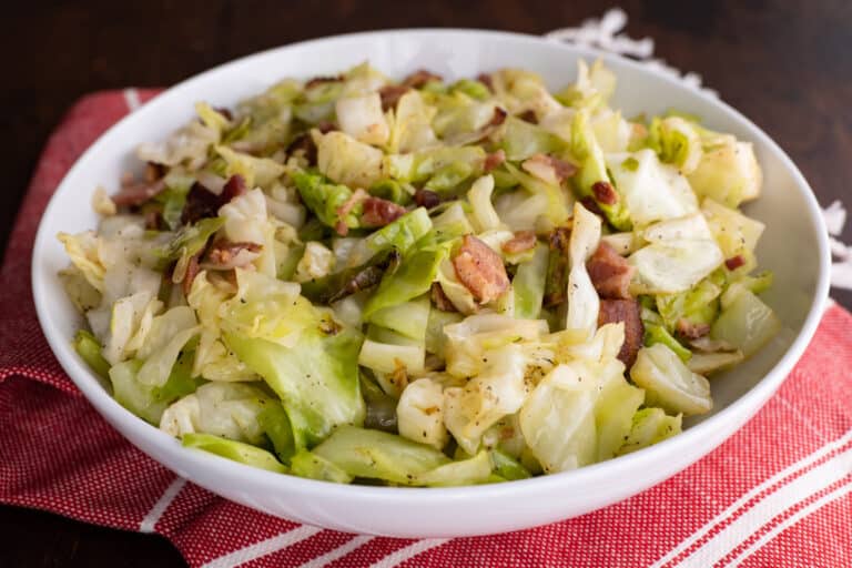 Fried cabbage with bacon in large serving bowl