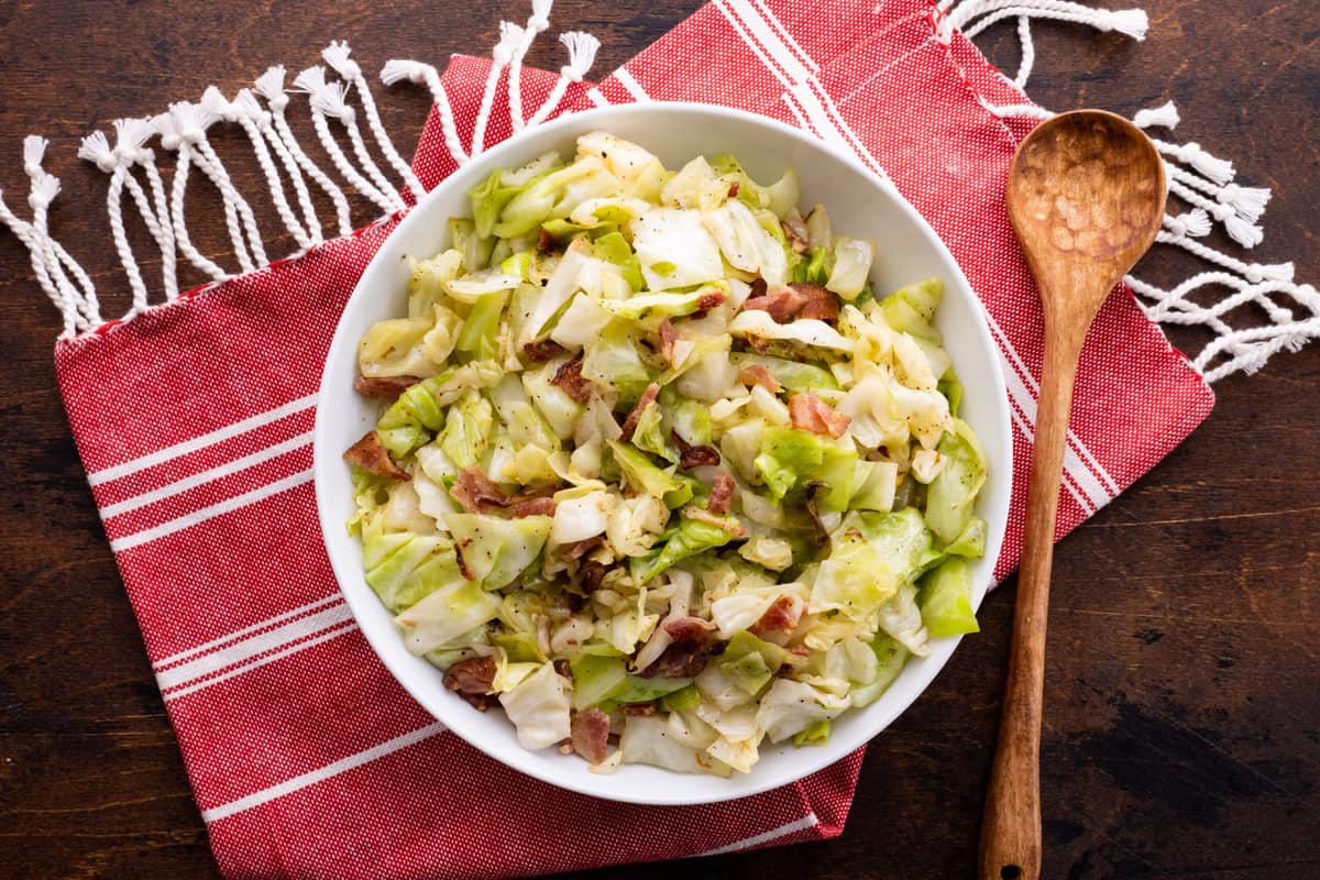 Fried cabbage with bacon in large serving bowl