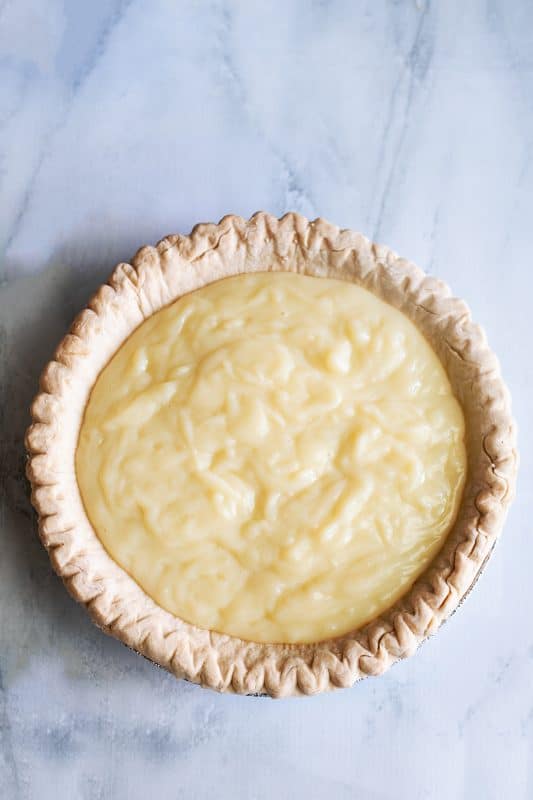 custard is covering the peanut butter crumbles in baked pie crust