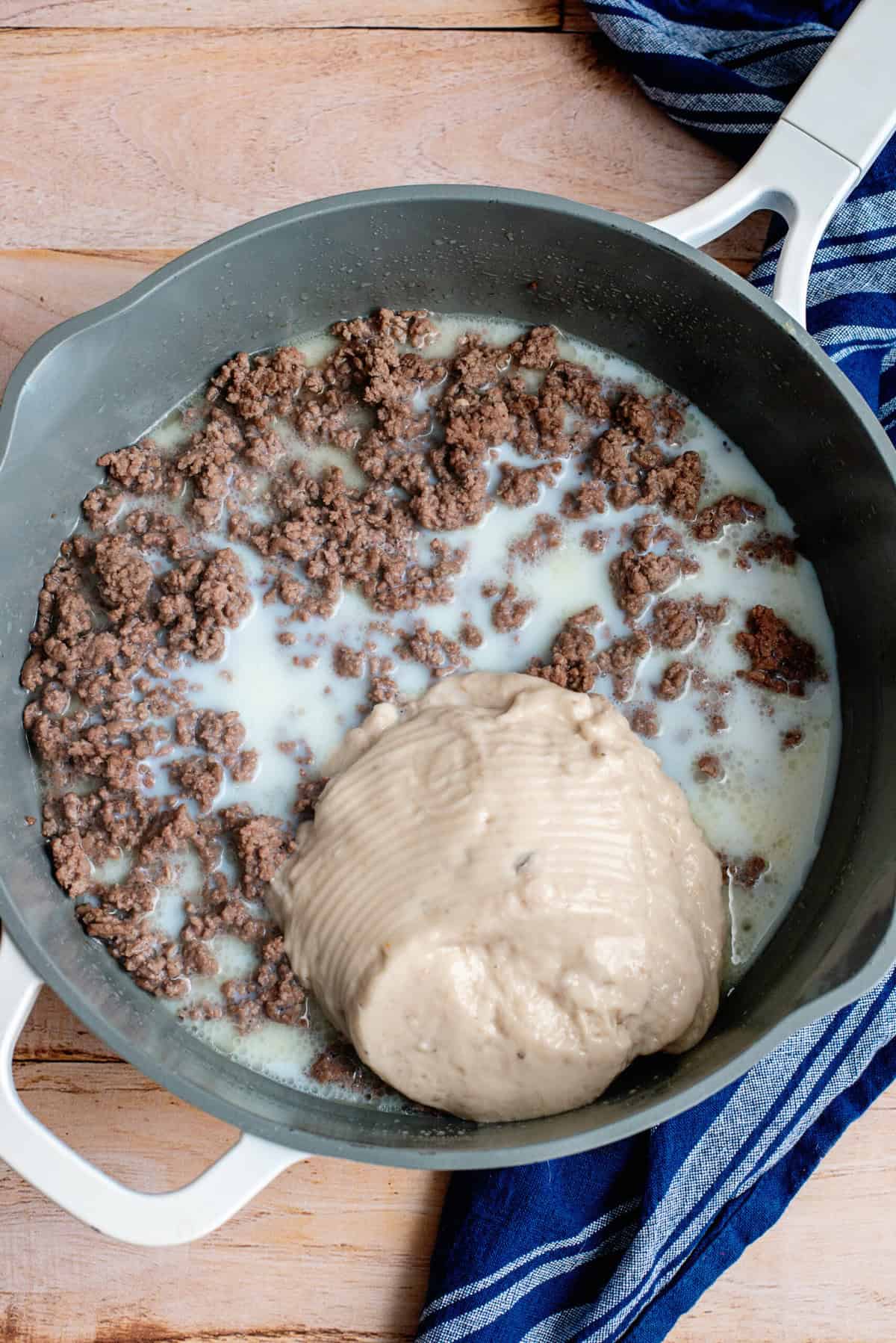 place ground beef, soup, and milk in a pot