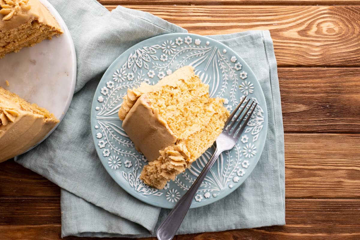 Slice of peanut butter cake with peanut butter frosting.