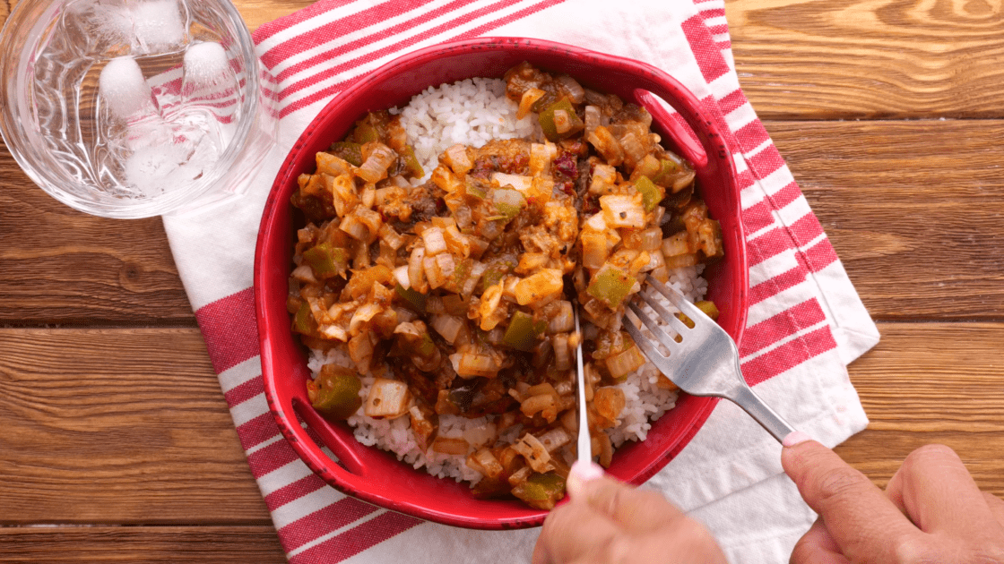 Hamburger patties with gravy and rice.