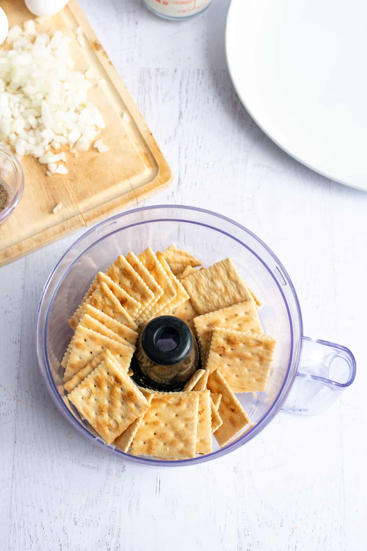 place saltines in a plastic bag or food processor