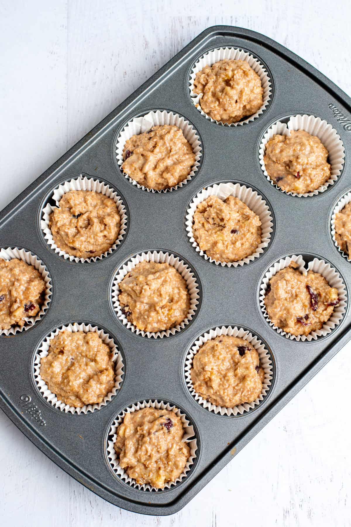 spoon muffin mix into muffin tin