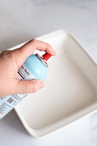 Spraying oil on baking dish