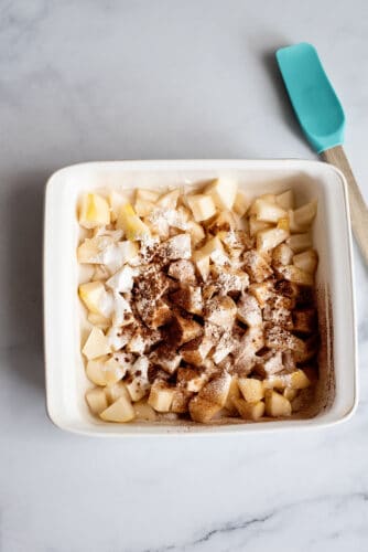 Cinnamon and flour sprinkled over diced pears.