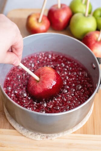 Dip apple into candy coating.