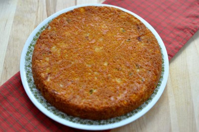 Turning Mexican cornbread over onto a large plate.