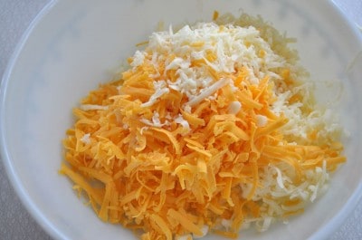 Add shredded cheese to mixing bowl.