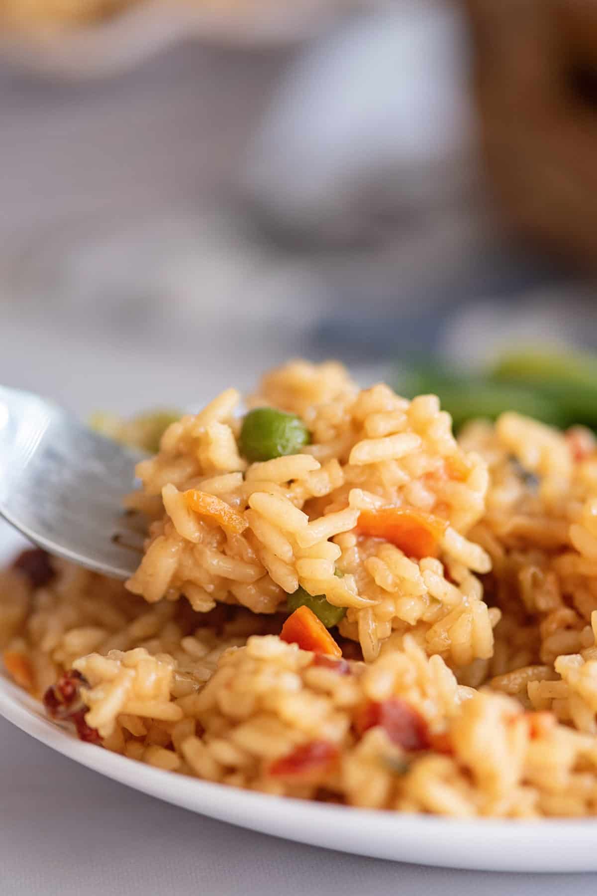 Fork digging into rice pilaf.