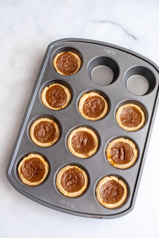 Cooked pies in tray.