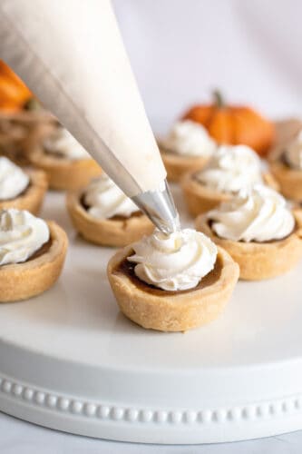 Add whipped cream to pies.