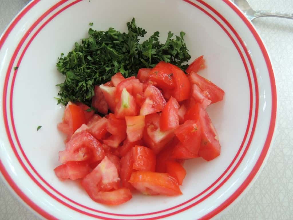 Chopped tomatoes and parsley in a bowl.