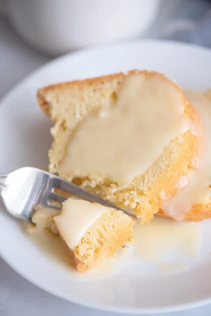 Fork breaking off piece of pound cake.
