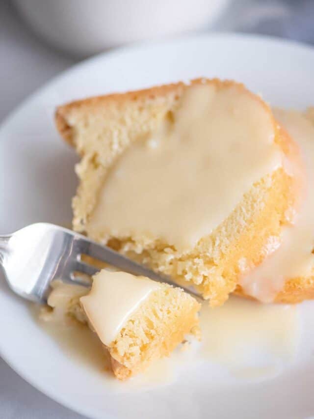 Fork breaking off piece of pound cake.