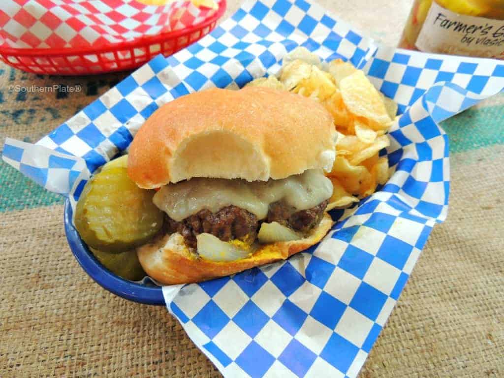 burger with chips in a basket on counter 