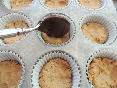 Top homemade peanut butter cups with melted chocolate.