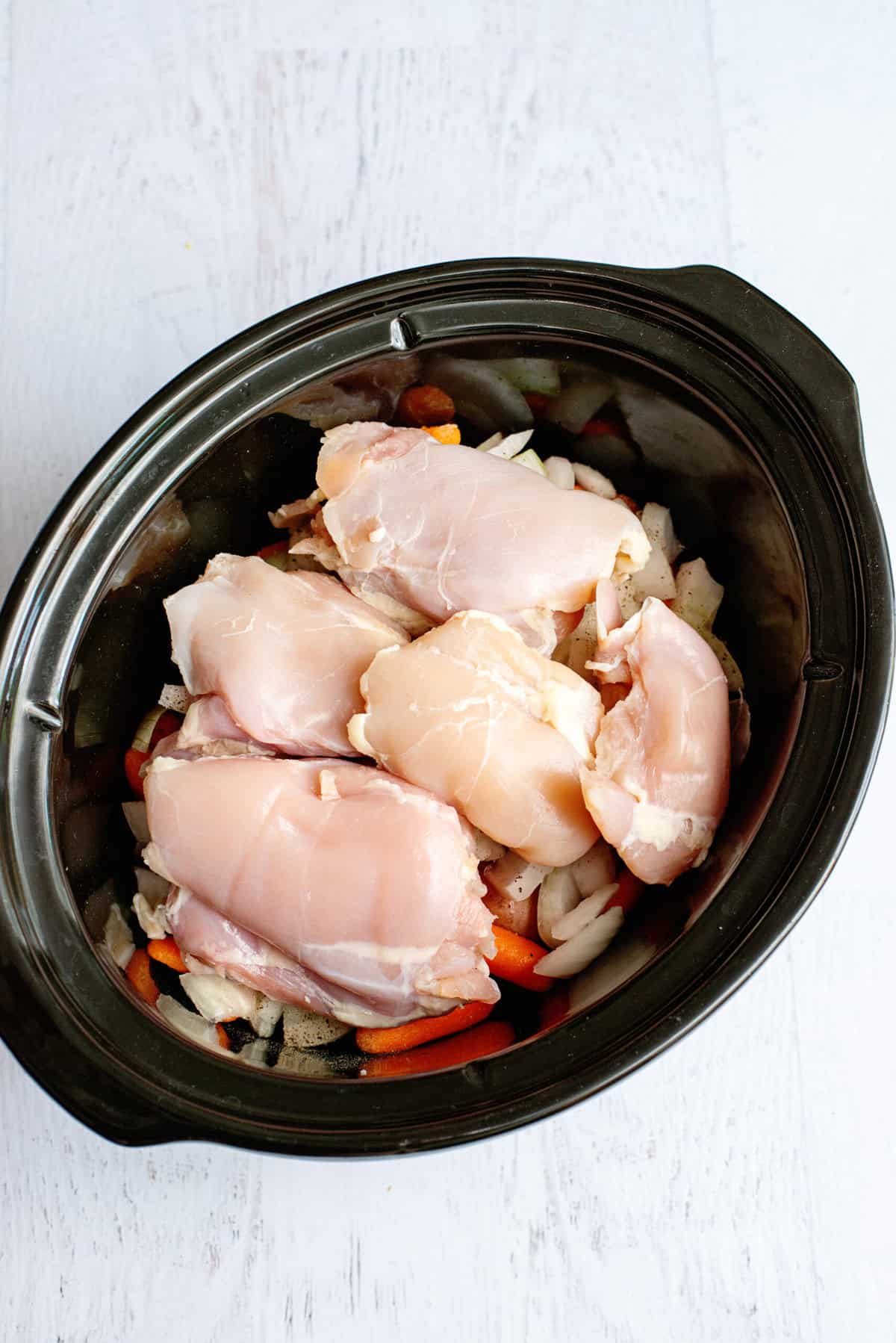 add the boneless chicken thighs to the crock pot