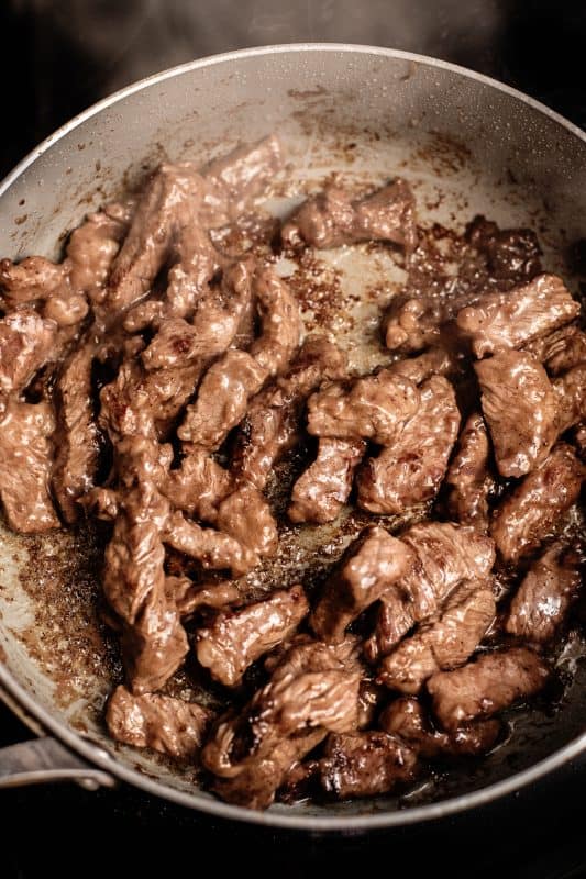 Cooked beef in skillet.