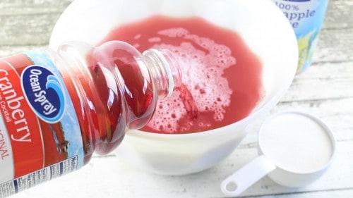 Mix together cranberry juice, pineapple juice, and sugar.