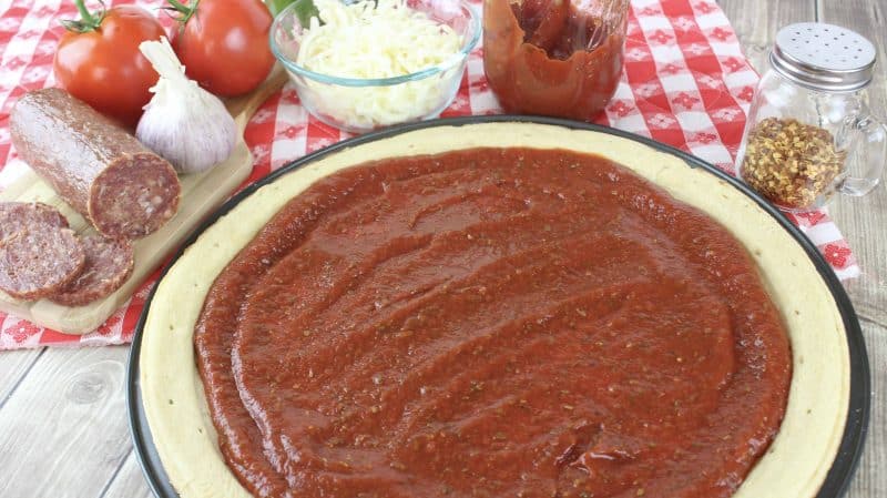 Quick Homemade Pizza Sauce spread onto a pizza.