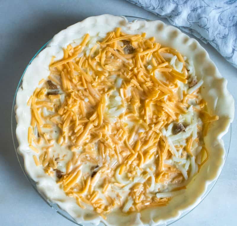 Top quiche with cheese.