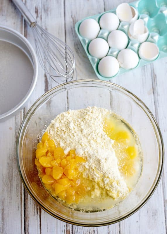 cake ingredients, unmixed, in a glass bowl.