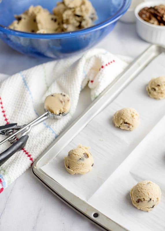 scooping out cookie dough onto cookie sheet