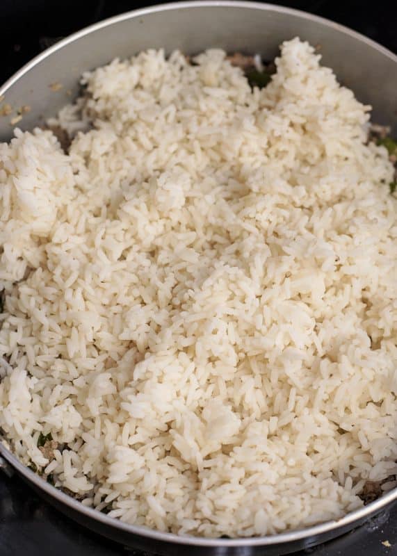 Add cooked rice to skillet.