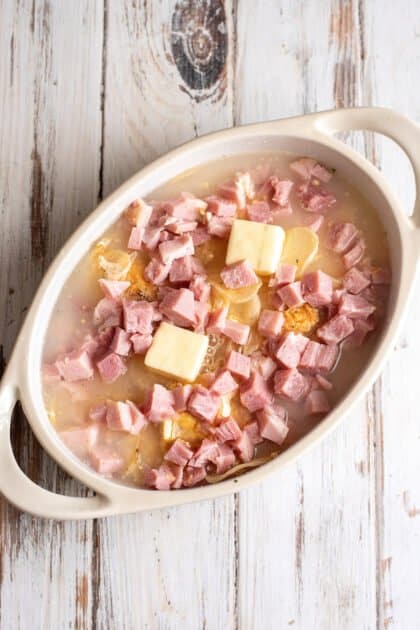 Give ham and potato casserole a good stir.