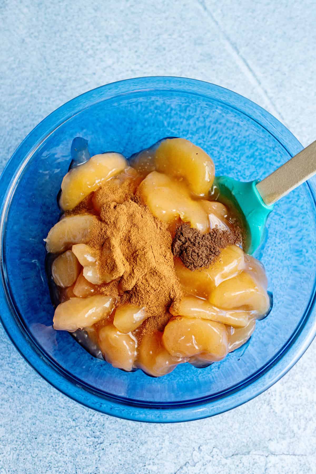 Add apples and spices to a bowl