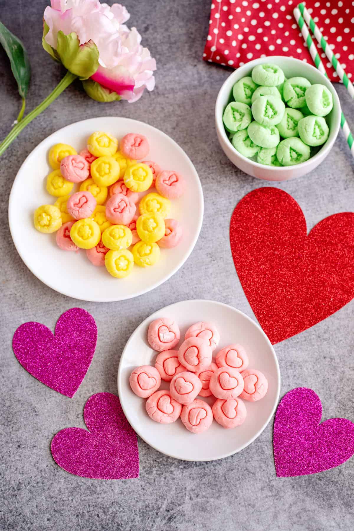 Multiple bowls of colorful cream cheese mints.