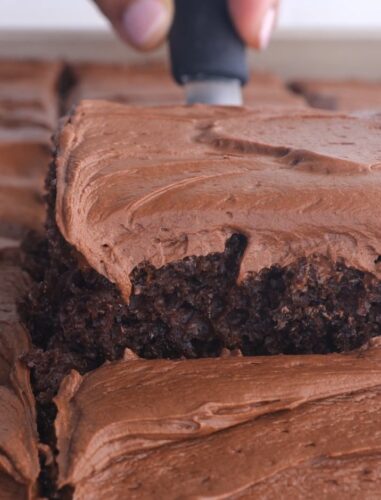 creamy chocolate frosting on a brownie slice.