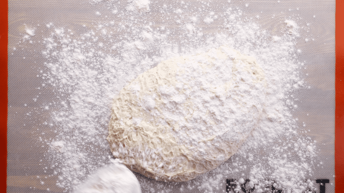 Sprinkle bread dough with more flour.