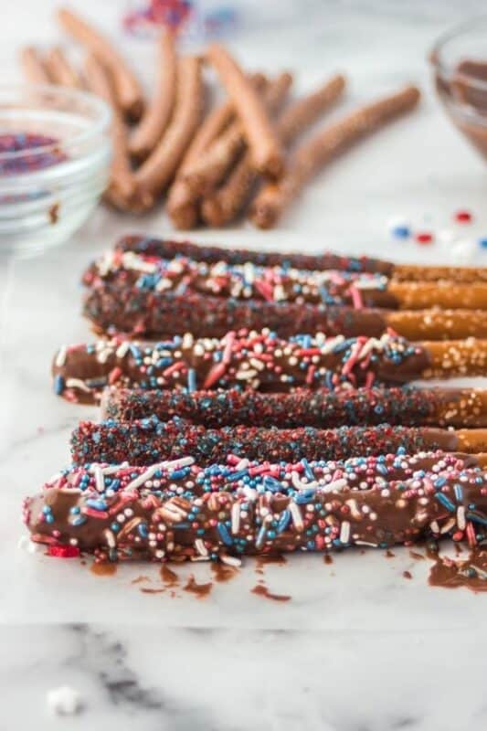 wax paper with chocolate pretzels laid out 